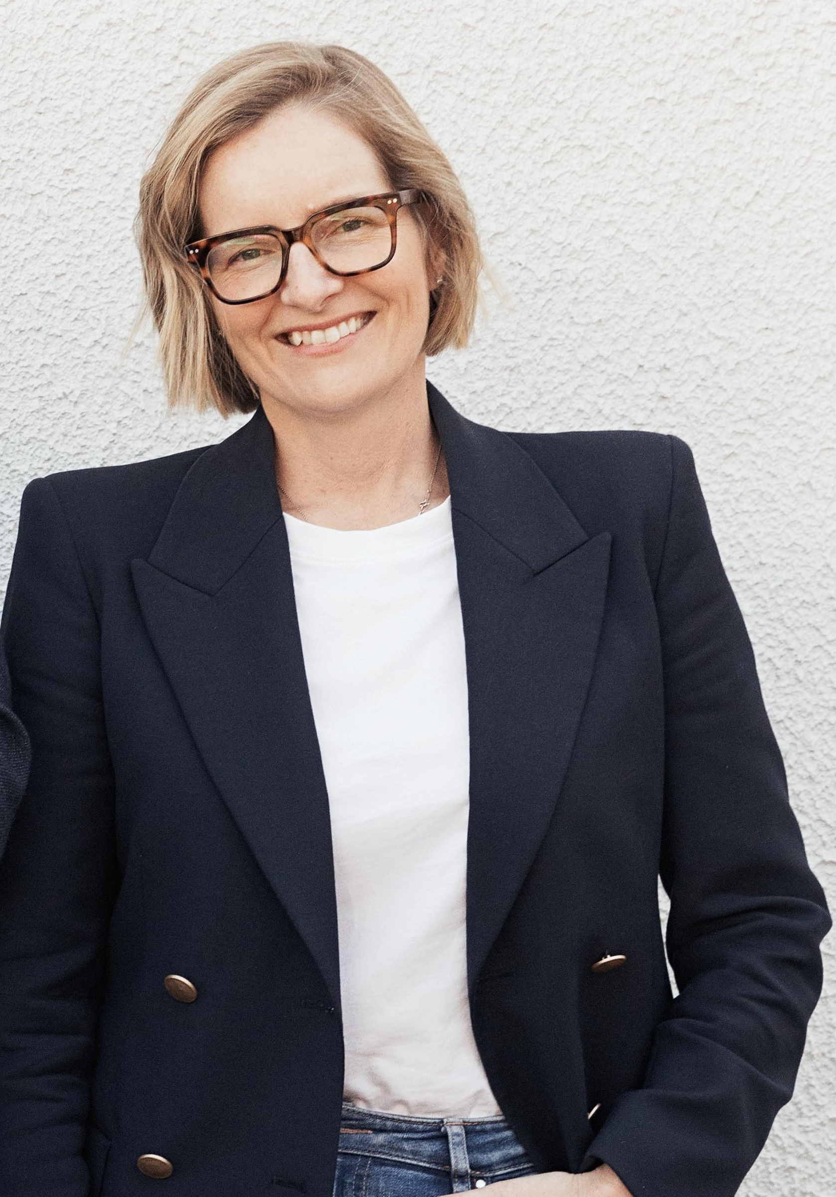 An image of C Murphy, standing and smiling